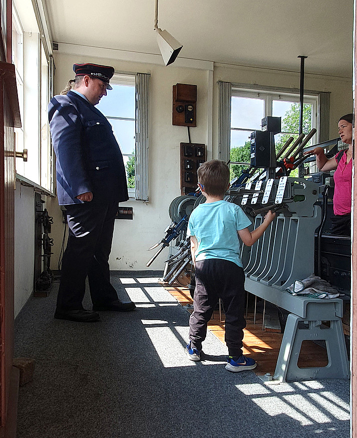 A child tries out the equipment in the signal box.