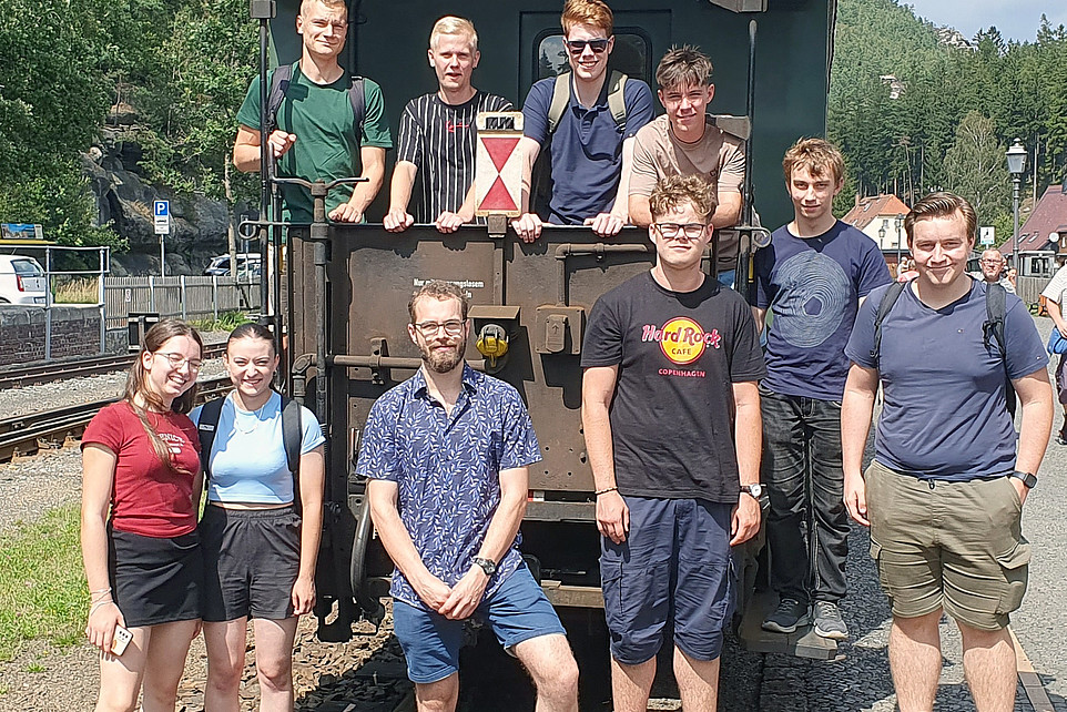 The participants pose for a group photo at the end of the Bimmelbahn train carriage.